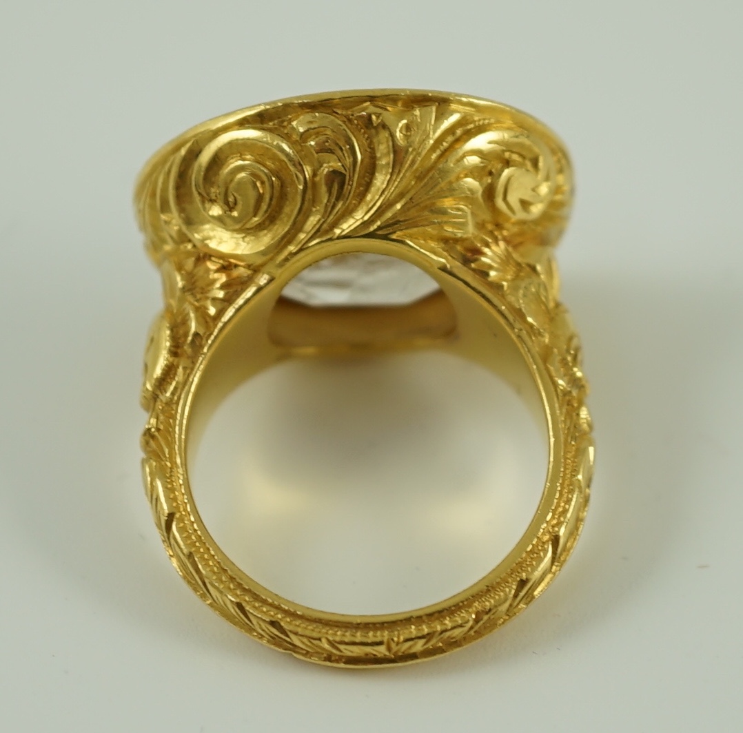 A large antique style gold and intaglio white stone set ring